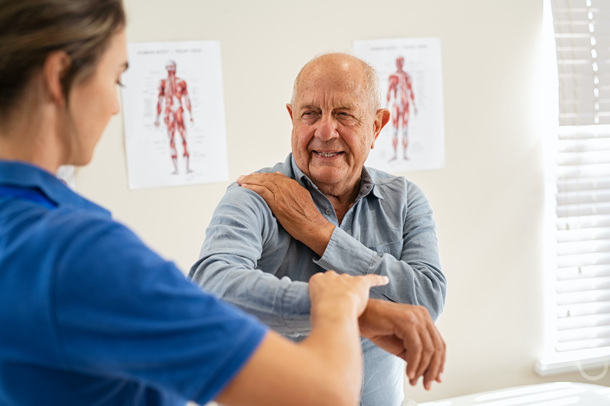 Physiotherapist working with senior patient in clinic